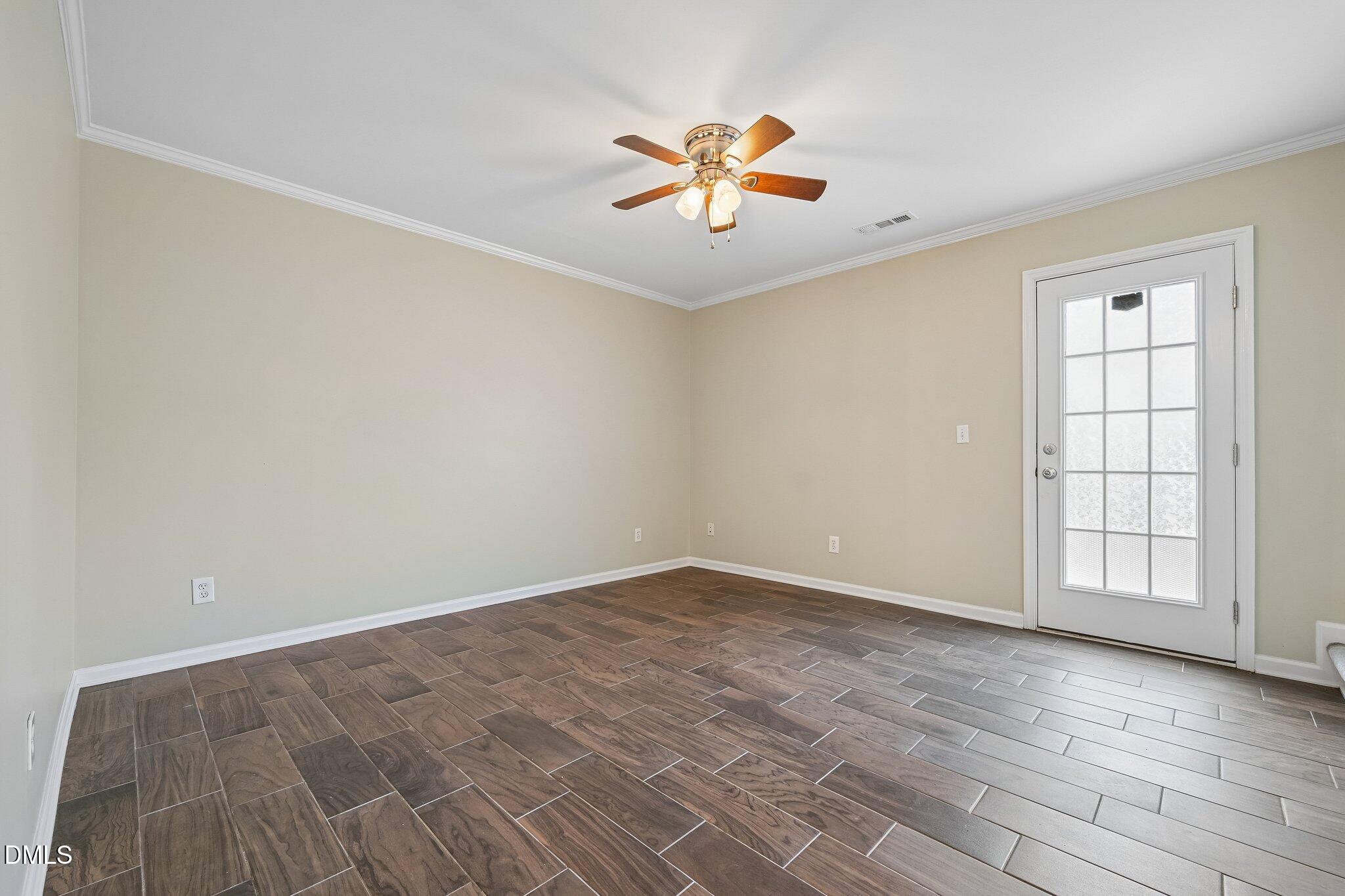 278 South Raleigh Street Angier, NC 27501 - Photo 4 of 35 wooden floor in an empty room with a window