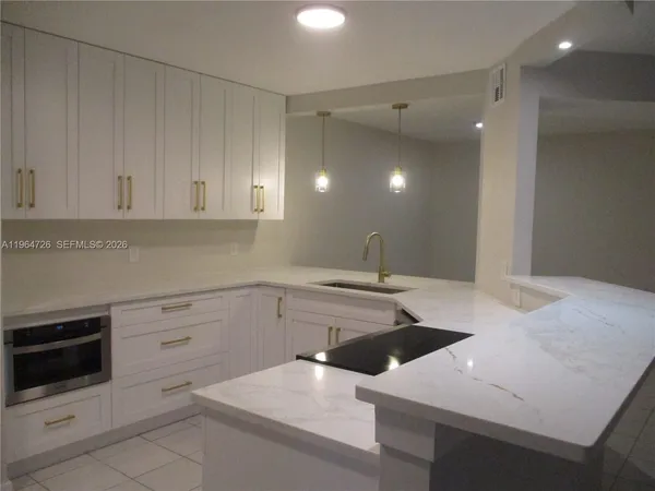 a kitchen with a sink and cabinets