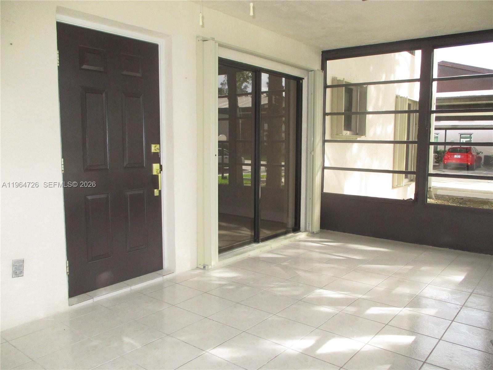 6531 Southeast Federal Highway, Unit F107 Stuart, FL 34997 - Photo 18 of 38 ENCLOSED PATIO WITH SLIDING DOORS INTO LIVING ROOM