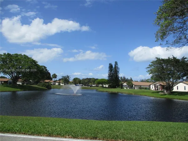 a view of a lake with houses in the back