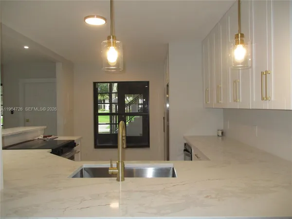 a view of a room with windows and chandelier