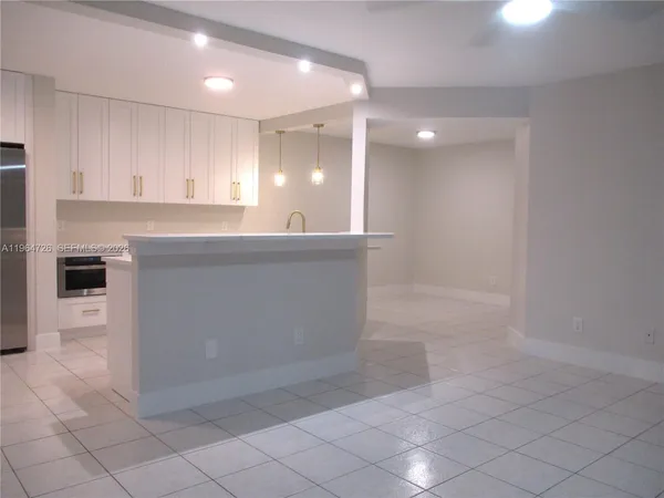 a large kitchen with cabinets and a sink