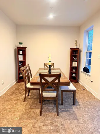 a dining room with furniture and wooden floor