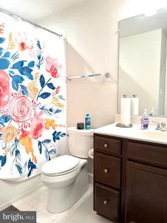 a bathroom with a sink vanity and a mirror