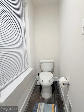 a bathroom with a sink toilet and a mirror