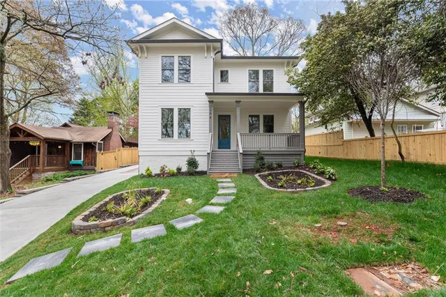 a view of a house with backyard and sitting area