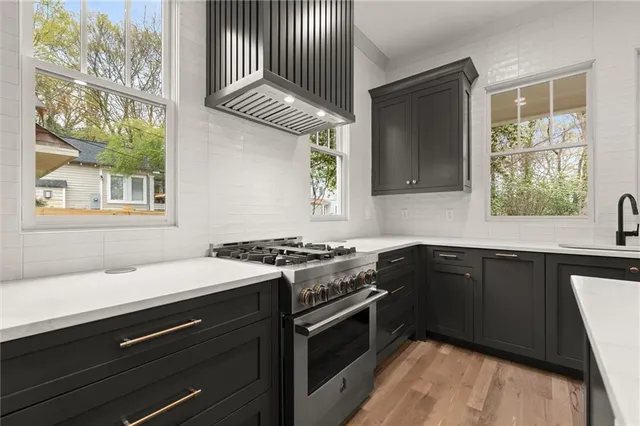 a kitchen with a sink and a wooden floor