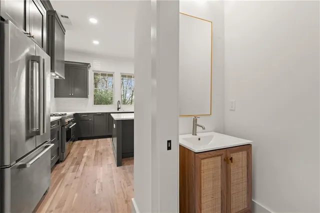 a view of a hallway with wooden floor and staircase