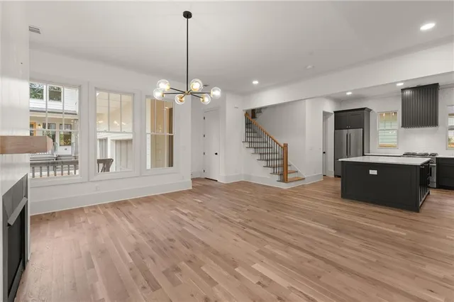 a view of a hallway with wooden floor and windows