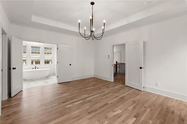 a white bath tub sitting in a bathroom next to a window