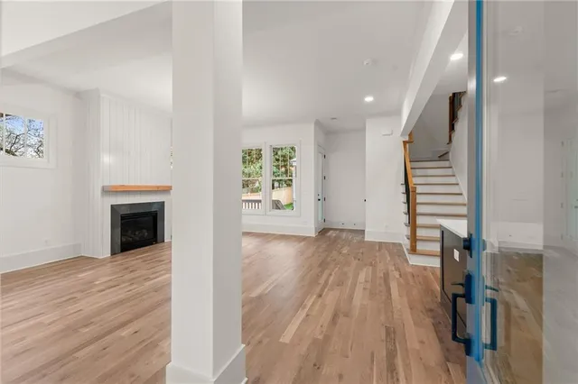 wooden floor in an empty room with a fireplace