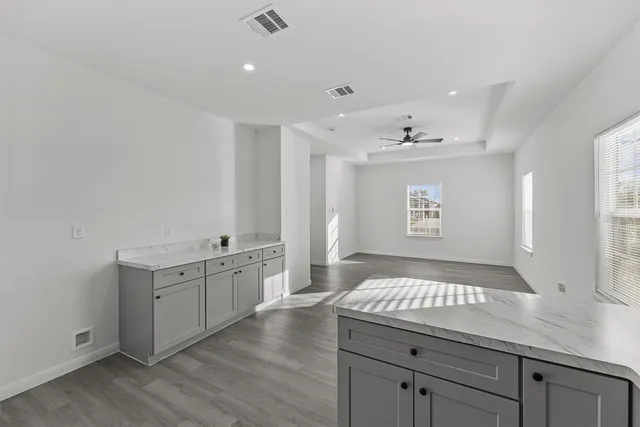 a spacious bathroom with a sink a large mirror and vanity