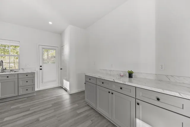 a view of a entrance and room with wooden floor