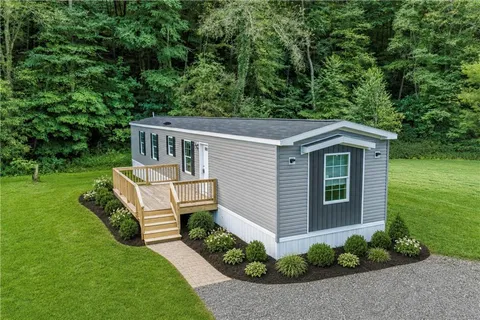 a view of a house with backyard and garden
