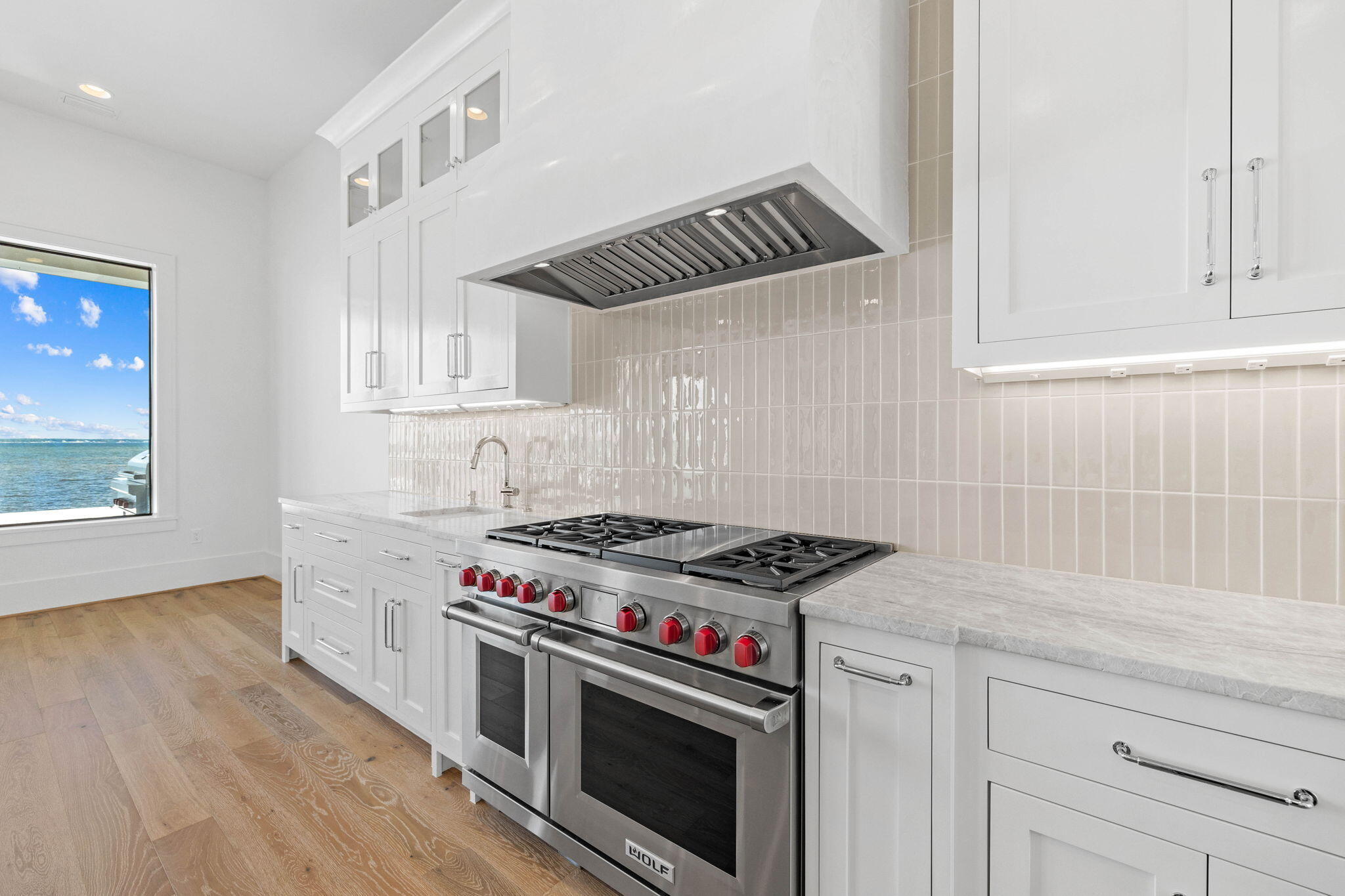 480 Captains Circle Destin, FL 32541 - Photo 13 of 63 a kitchen with granite countertop a stove and a sink