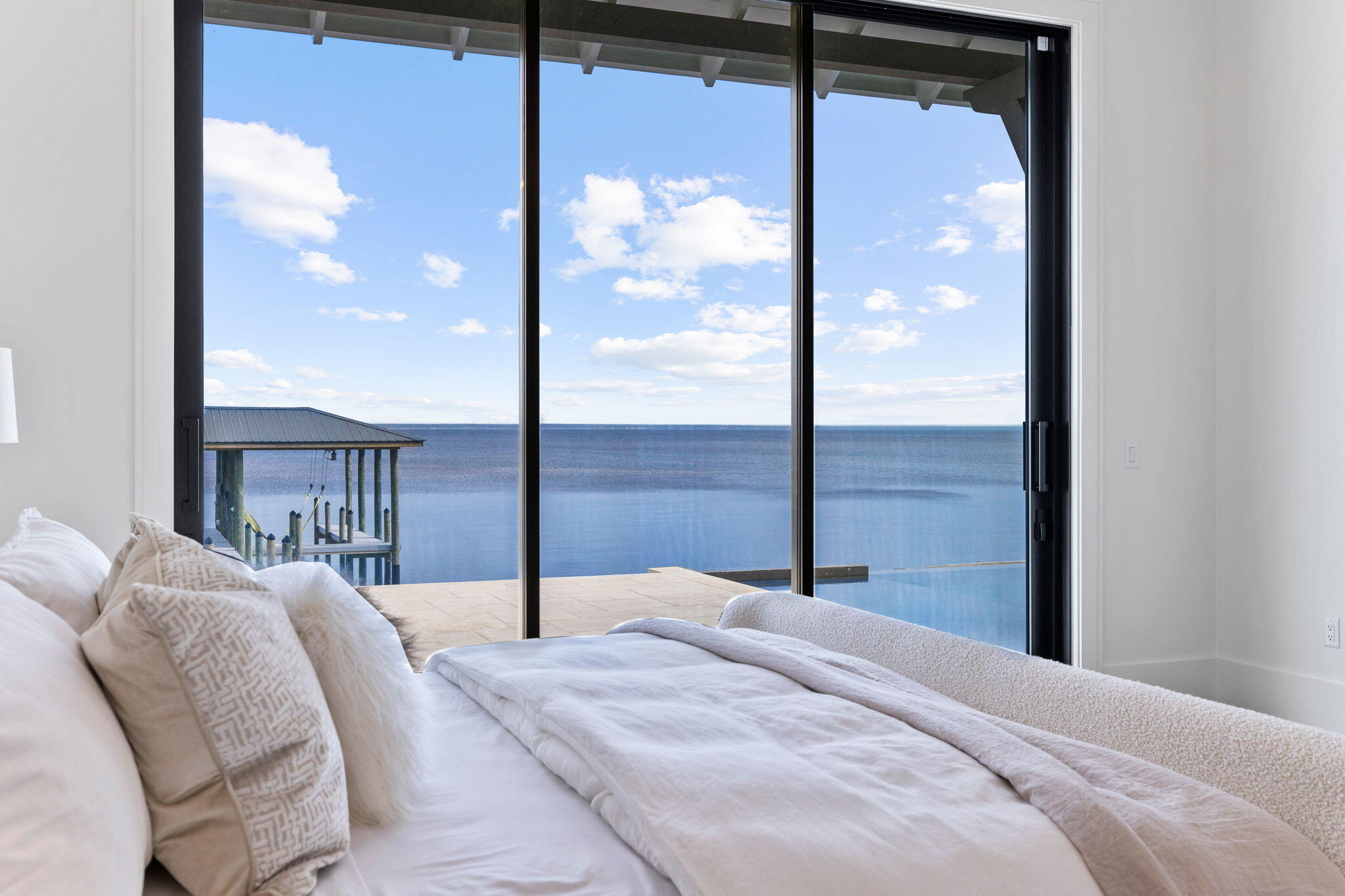 480 Captains Circle Destin, FL 32541 - Photo 19 of 63 a bedroom with a large bed and a chandelier