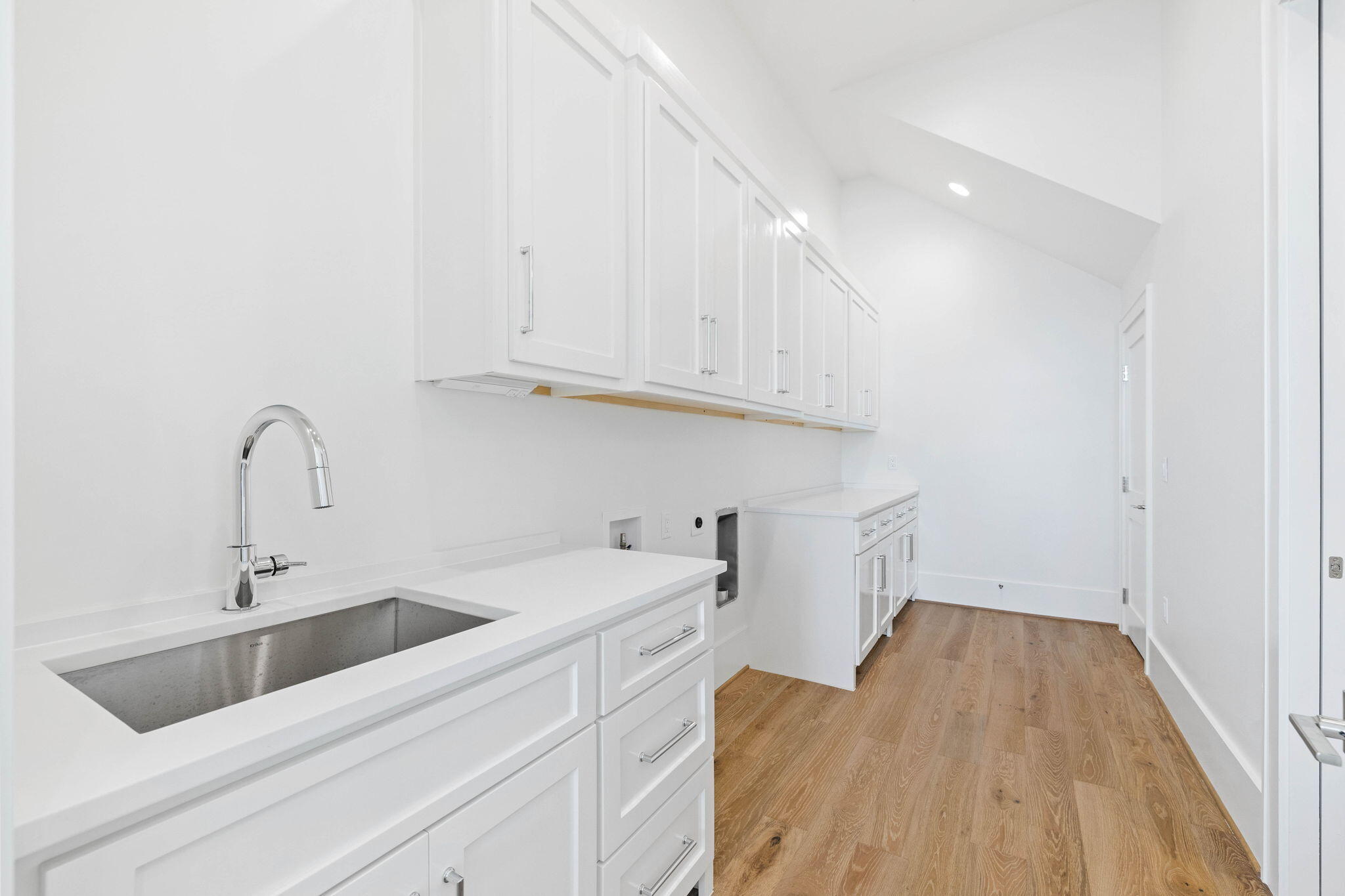 480 Captains Circle Destin, FL 32541 - Photo 28 of 63 a view of a kitchen counter space a sink wooden floor and entryway