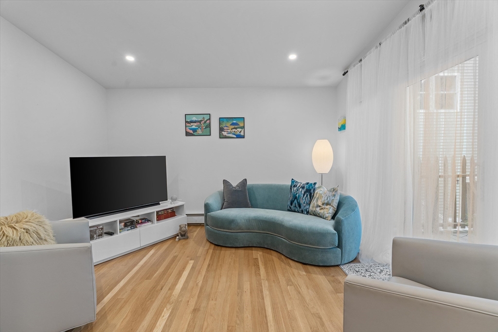 402 East 7th Street, Unit 2 Boston, MA 02127 - Photo 1 of 19 a living room with furniture and a flat screen tv