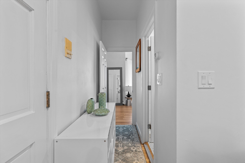 402 East 7th Street, Unit 2 Boston, MA 02127 - Photo 11 of 19 a hallway with sliding door and wooden floor