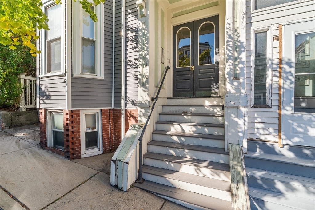 402 East 7th Street, Unit 2 Boston, MA 02127 - Photo 15 of 19 a view of a brick house with a large windows and a potted plant