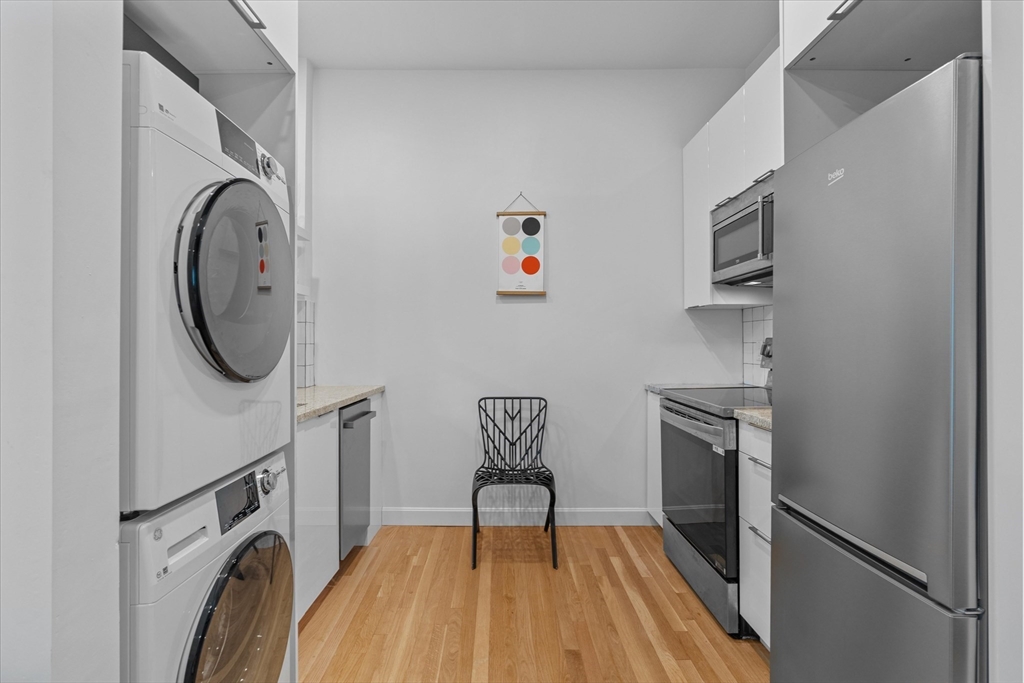 402 East 7th Street, Unit 2 Boston, MA 02127 - Photo 4 of 19 a view of a storage and utility room with washer and dryer