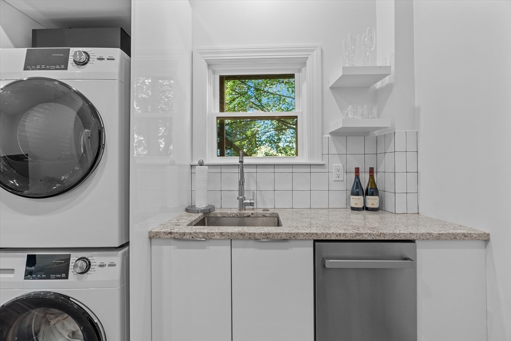 402 East 7th Street, Unit 2 Boston, MA 02127 - Photo 5 of 19 a bathroom with a granite countertop a sink a washer and dryer