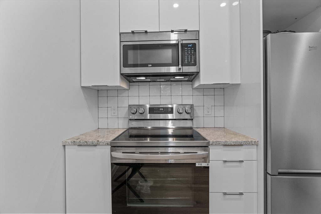 402 East 7th Street, Unit 2 Boston, MA 02127 - Photo 6 of 19 a kitchen with a stove and a microwave