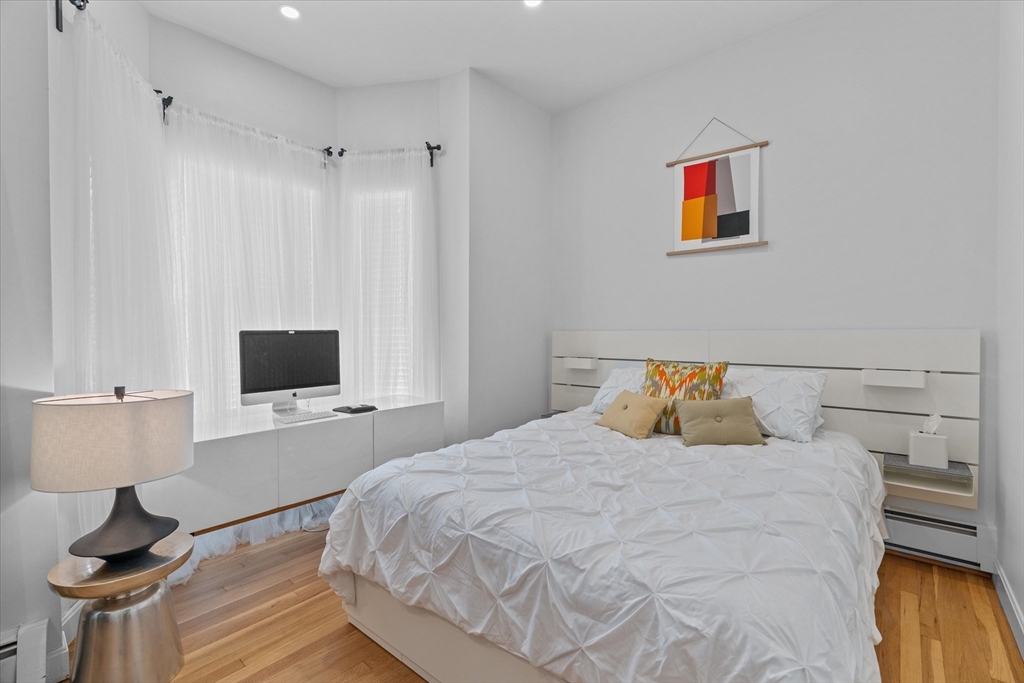 402 East 7th Street, Unit 2 Boston, MA 02127 - Photo 9 of 19 a bedroom with a bed and a flat screen tv