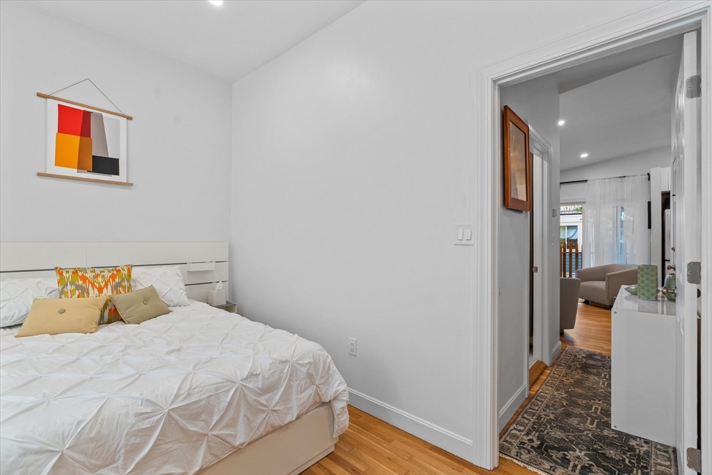 402 East 7th Street, Unit 2 Boston, MA 02127 - Photo 10 of 19 a bedroom with a bed and wooden floor