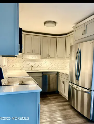 a kitchen with stainless steel appliances granite countertop a refrigerator sink and stove