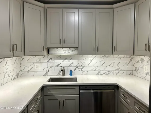 a kitchen with a sink and cabinets