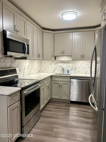 a kitchen with granite countertop a sink and steel stainless steel appliances