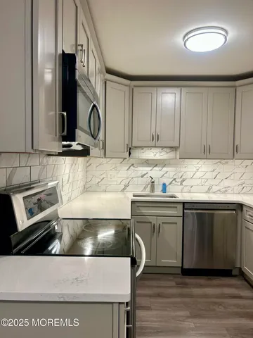 a kitchen with stainless steel appliances granite countertop a sink and cabinets