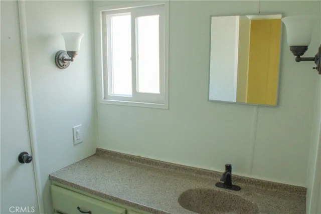 a bathroom with a sink and a window