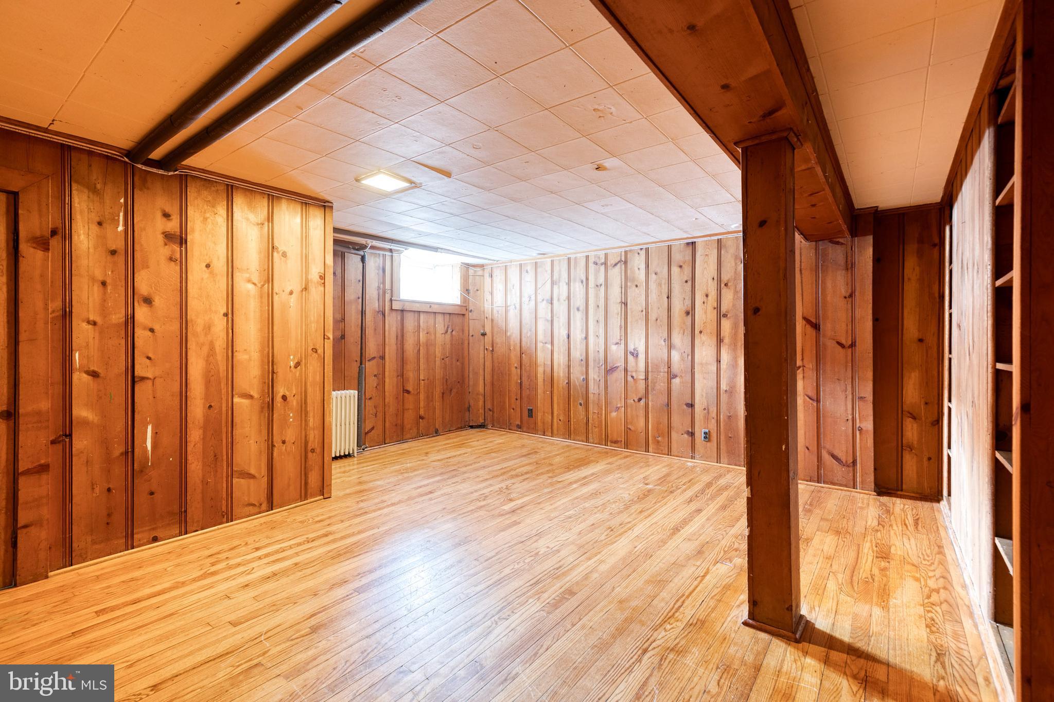 3918 Beech Avenue Baltimore, MD 21211 - Photo 20 of 24 a view of a room with wooden walls and stairs