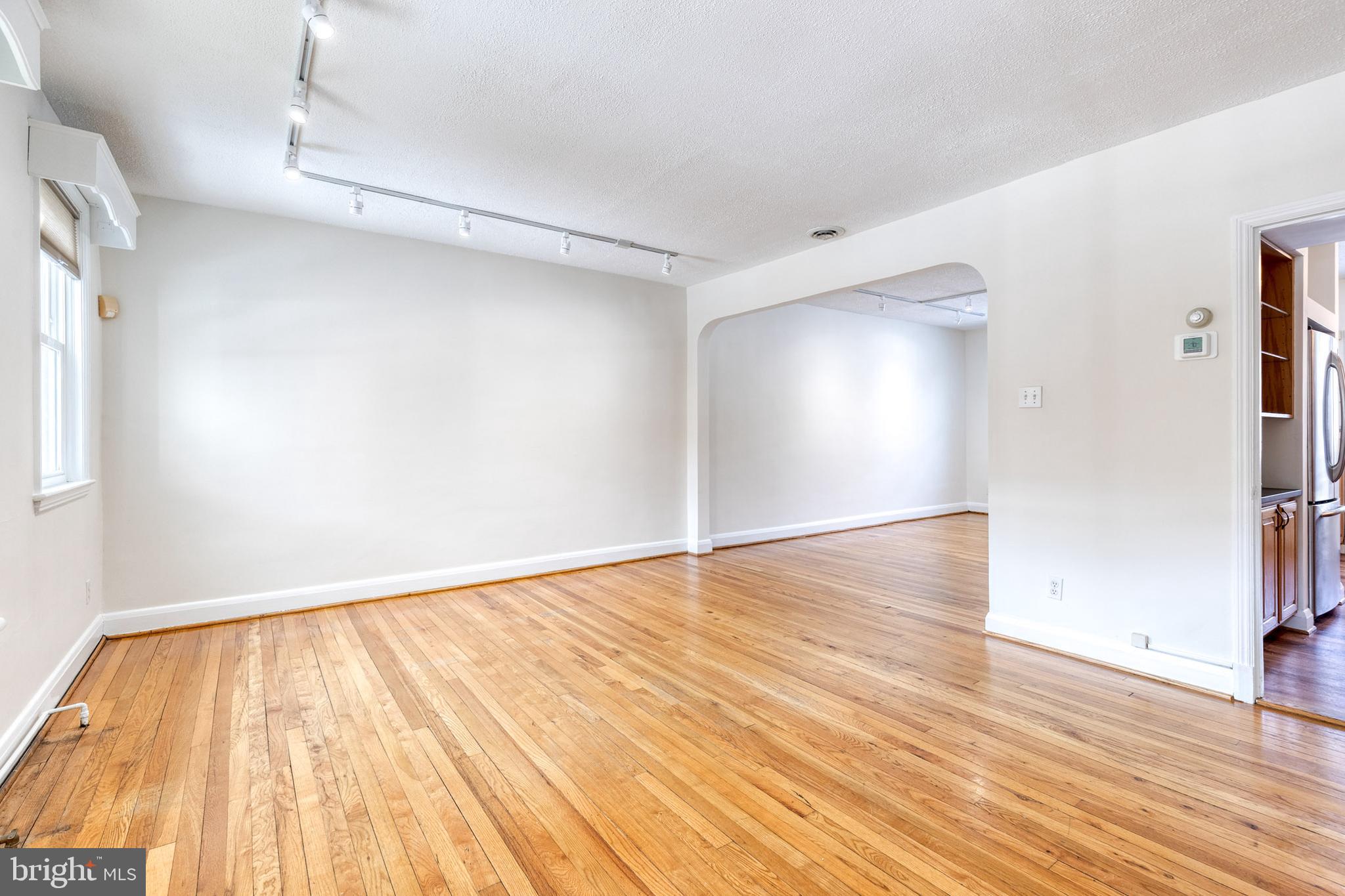 3918 Beech Avenue Baltimore, MD 21211 - Photo 3 of 24 a view of empty room with wooden floor