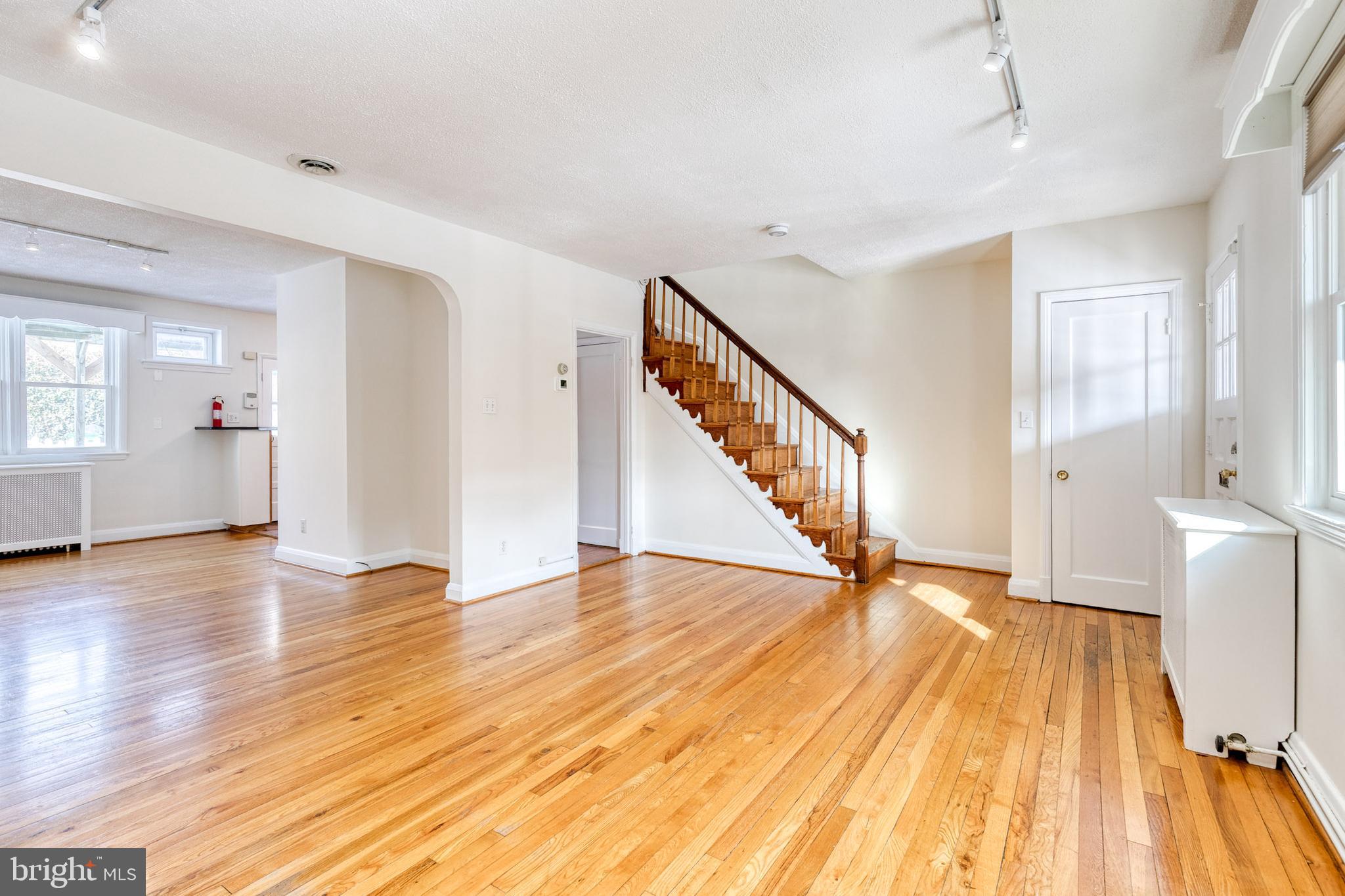 3918 Beech Avenue Baltimore, MD 21211 - Photo 4 of 24 a view of an empty room with wooden floor and a window