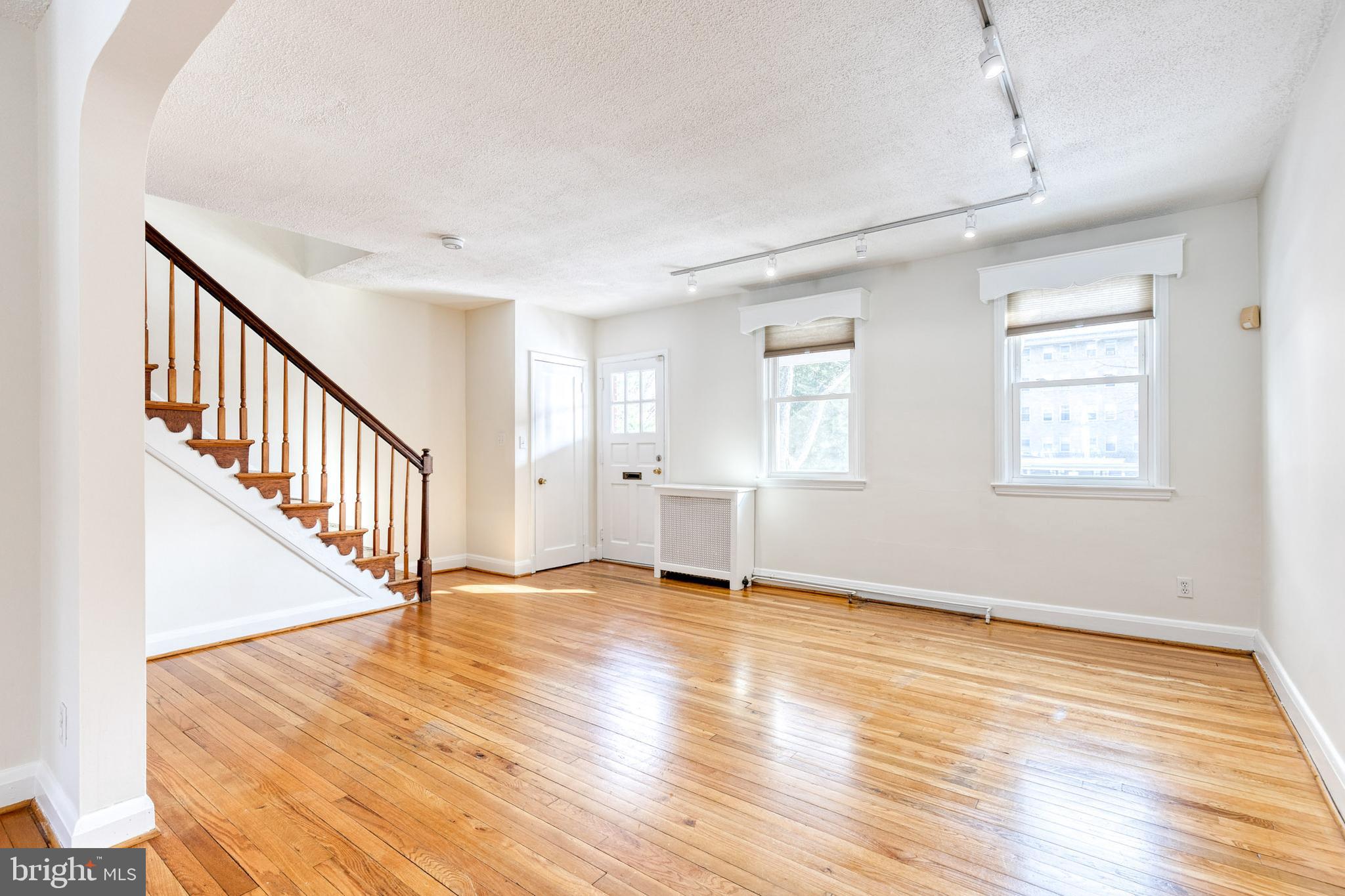 3918 Beech Avenue Baltimore, MD 21211 - Photo 6 of 24 a view of an empty room with wooden floor and a window