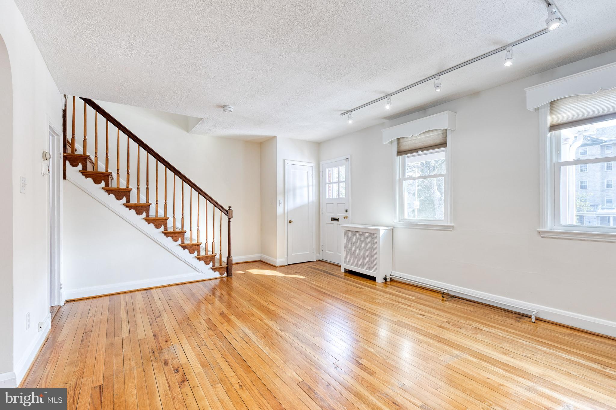 3918 Beech Avenue Baltimore, MD 21211 - Photo 7 of 24 a view of an empty room with wooden floor and a window