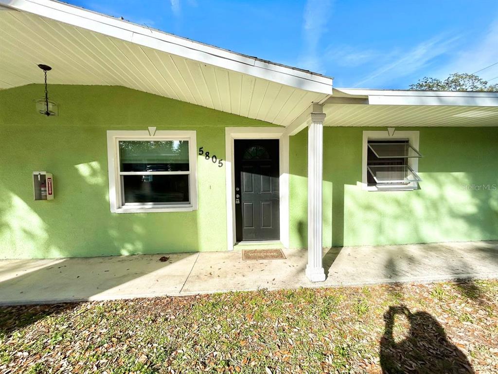 5805 Delaware Avenue New Port Richey, FL 34652 - Photo 1 of 12 a front view of a house with a yard
