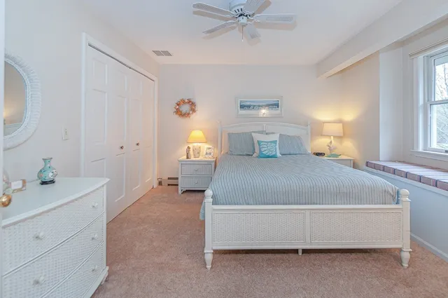 a spacious bedroom with a bed and a table in it