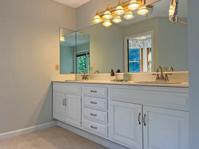 a bathroom with a double vanity sink and a mirror