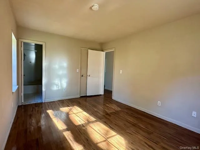 a view of an empty room and wooden floor