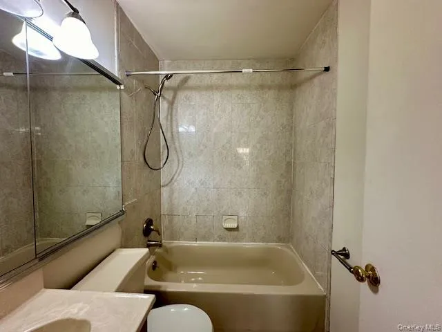 a bathroom with a shower and a bath tub