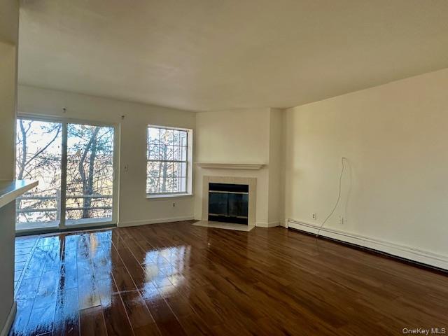 13 Lexington Hills Road, Unit 8 Harriman, NY 10926 - Photo 3 of 18 wooden floor fireplace and windows in an empty room
