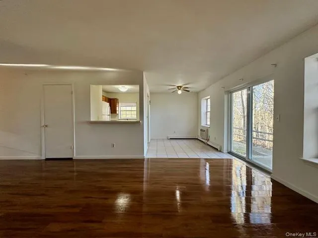 a view of a room with wooden floor and window