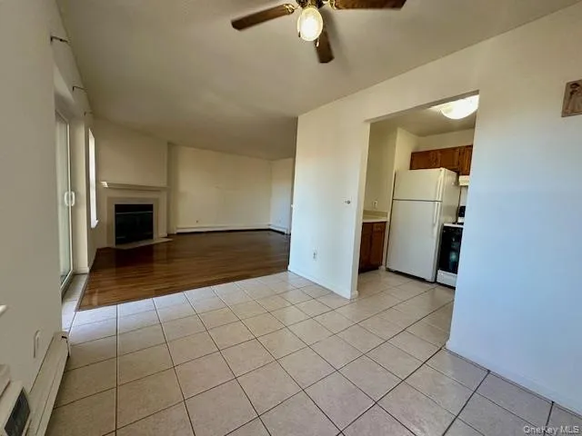 an empty room with fireplace and wooden floor