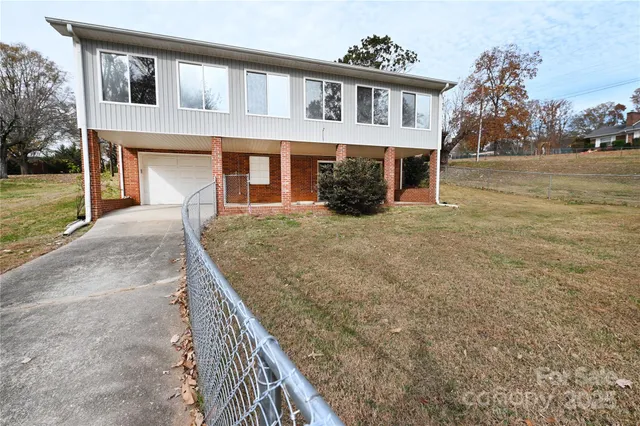 a view of house with yard and entertaining space
