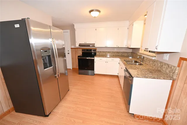 a kitchen with a refrigerator a sink and a stove