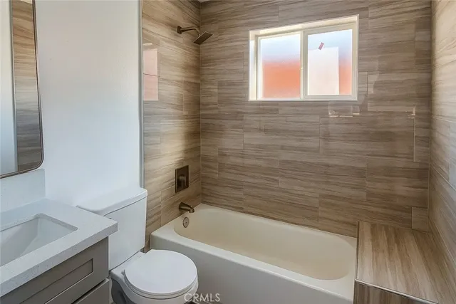 a bathroom with a toilet a sink and bathtub